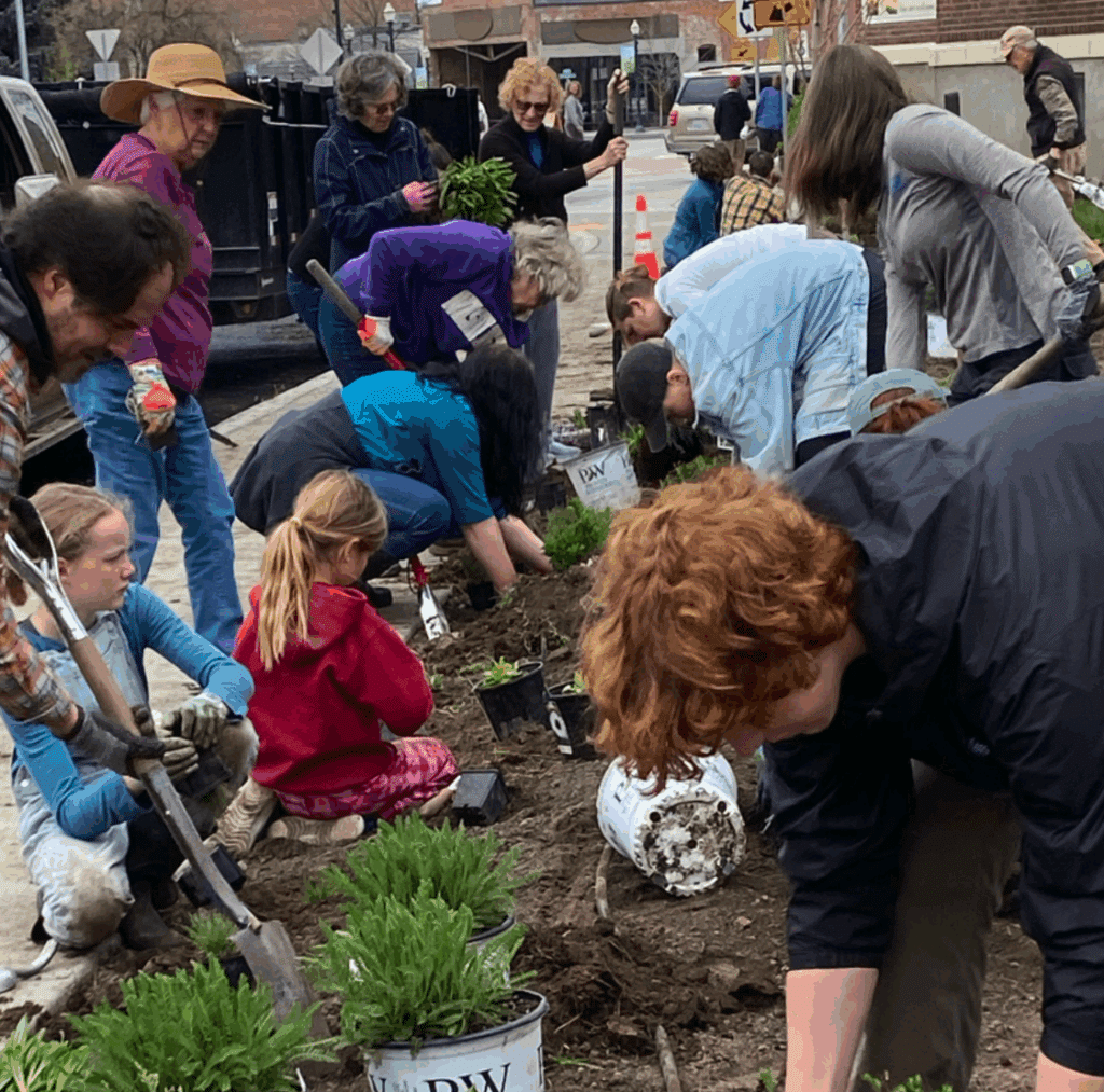 Children and adults working together in the garden.